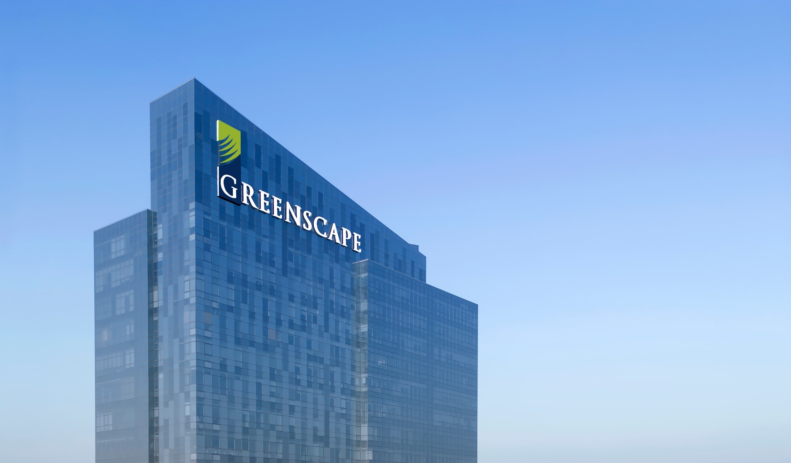 Greenscape sustainable commercial tower with glass facade against a clear sky