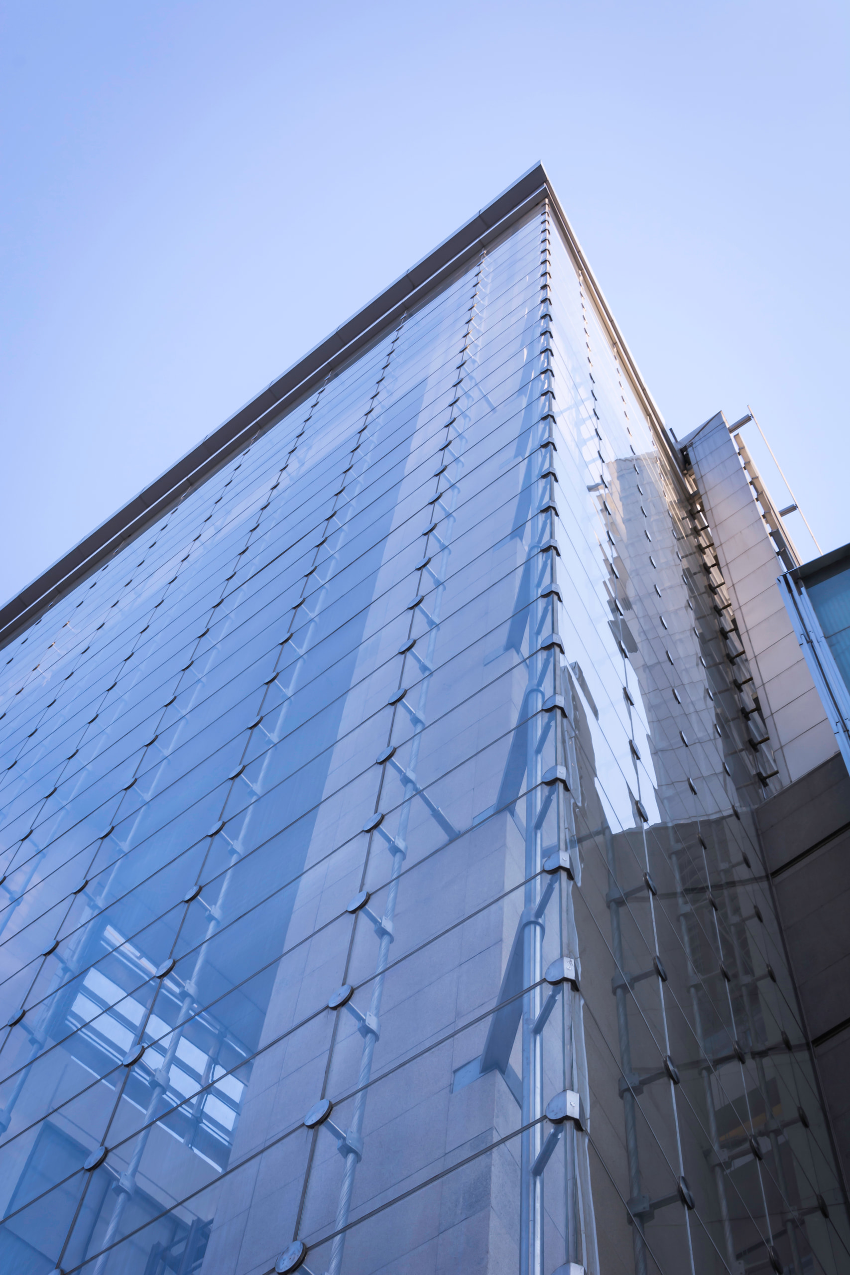 Upward view of the glass facade at Cyber Works